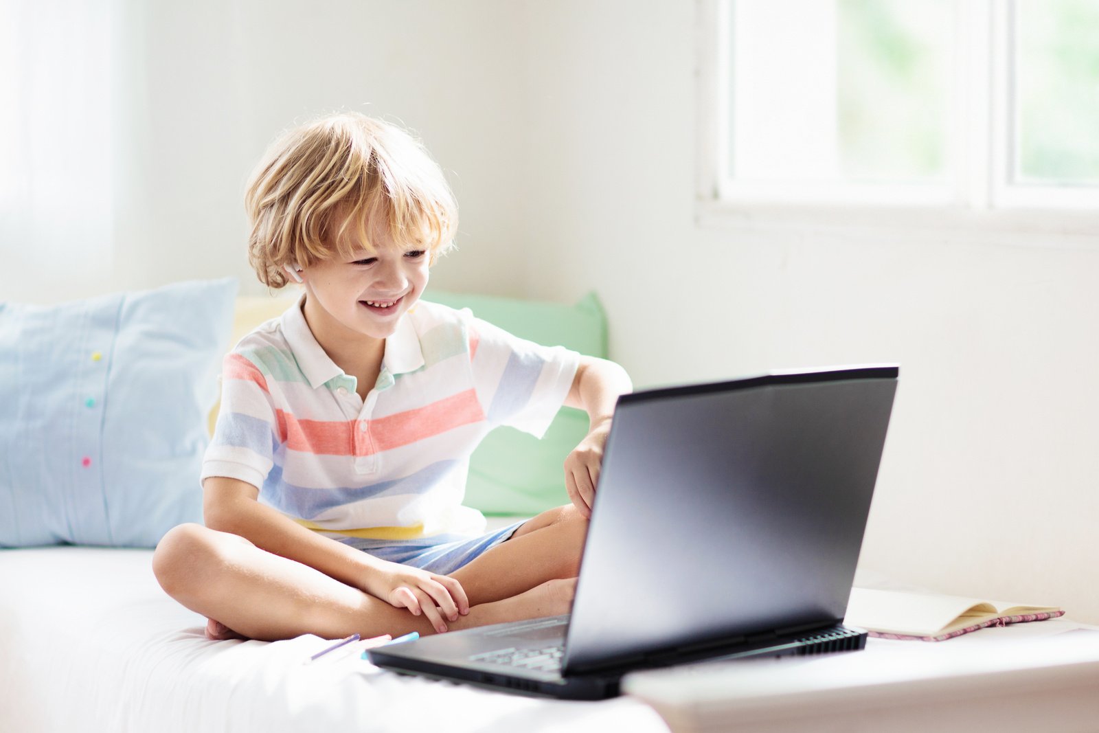 Online remote learning. School kids with computer.